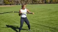 Woman using the TRX RIP Trainer in the park